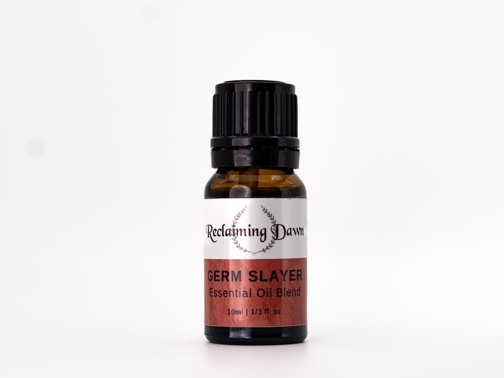Bottle of 'Germ Slayer' essential oil blend by Reclaiming Dawn on a white background