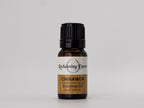 Bottle of Reclaiming Dawn Cinnamon essential oil on a gray background
