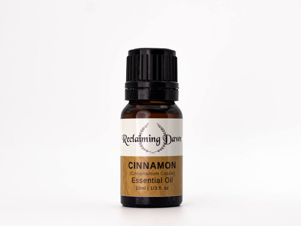 Bottle of Reclaiming Dawn Cinnamon essential oil on a white background