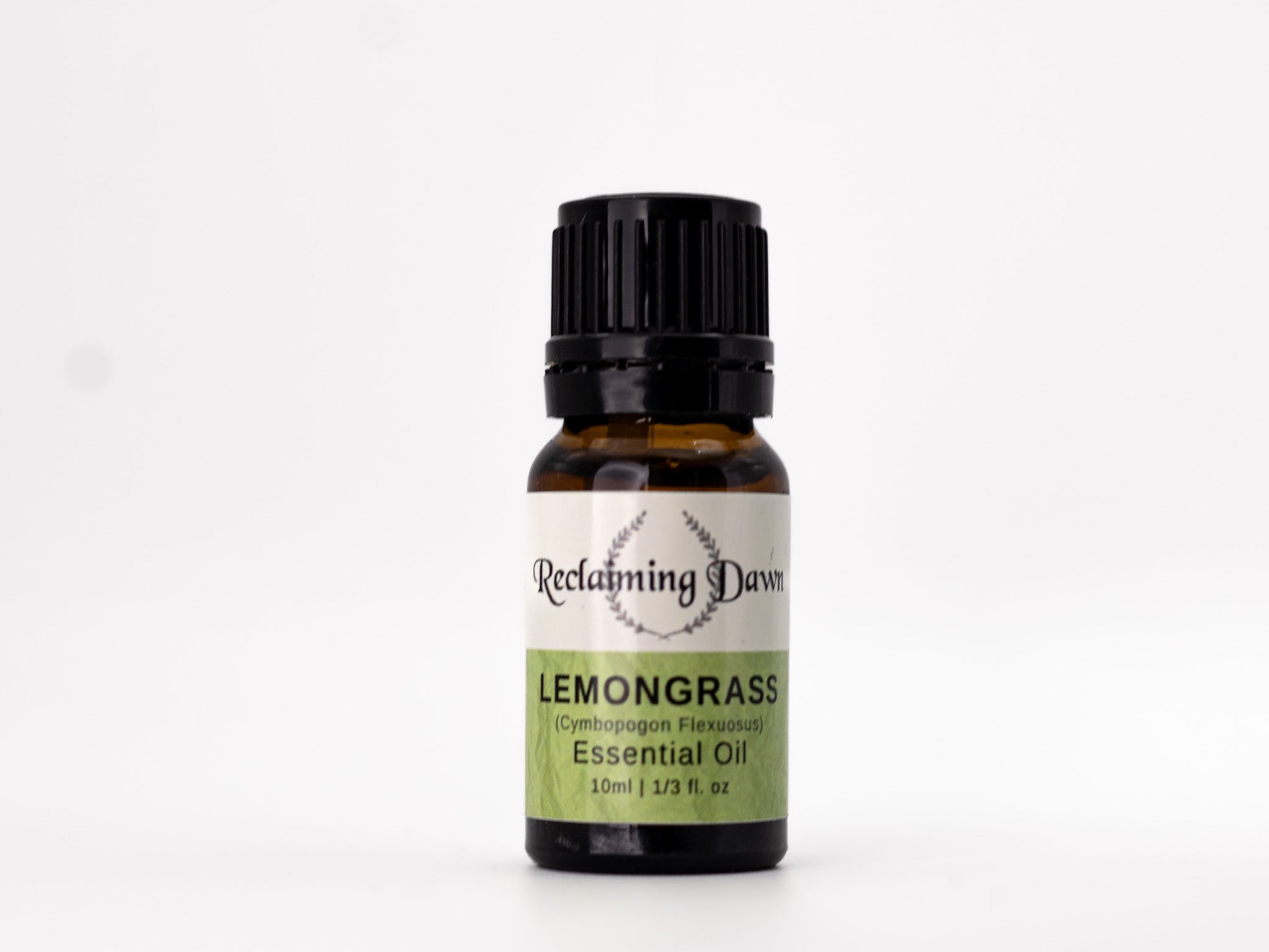 Bottle of Reclamimg Dawn Lemongrass essential oil on a white background