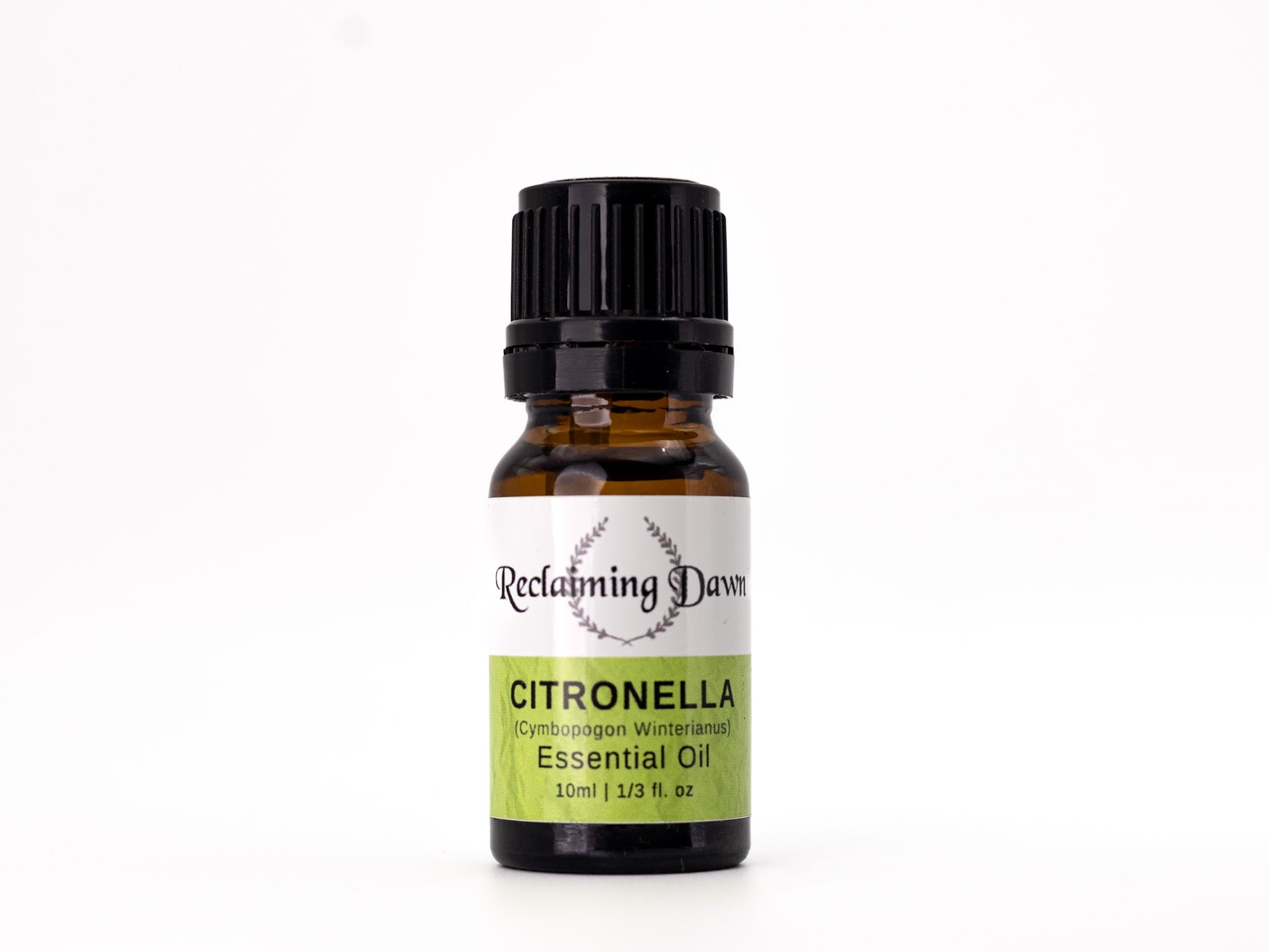 Bottle of Reclamimg Dawn Citronella essential oil on a white background