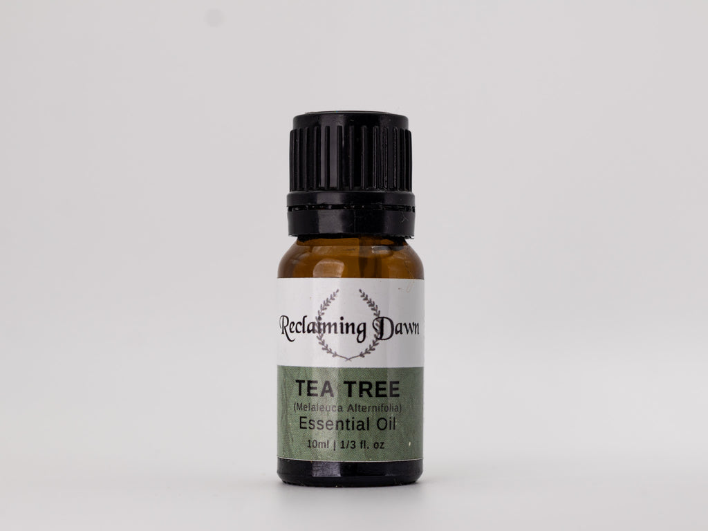 Tea tree essential oil bottle with 'Reclaiming Dawn' label on a white background