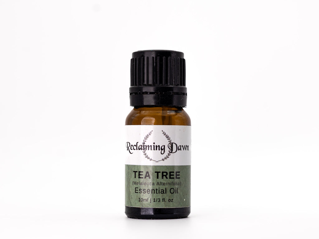 Tea tree essential oil bottle with 'Reclaiming Dawn' label.