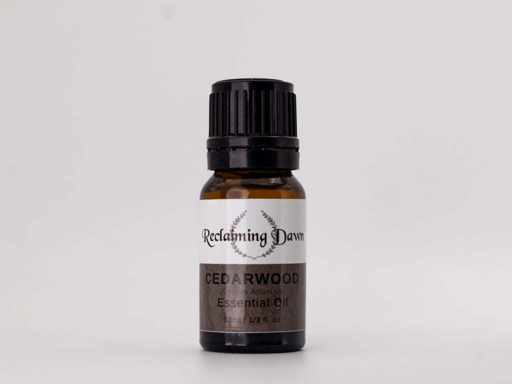 Bottle of Reclaiming Dawn Cedarwood essential oil on a white background