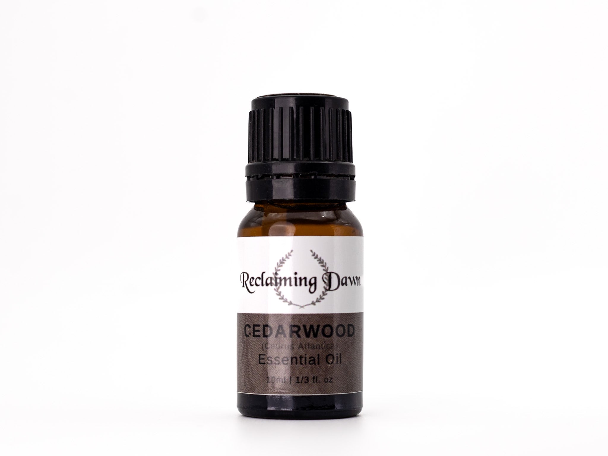 Bottle of Reclaiming Dawn Cedarwood essential oil on a white background