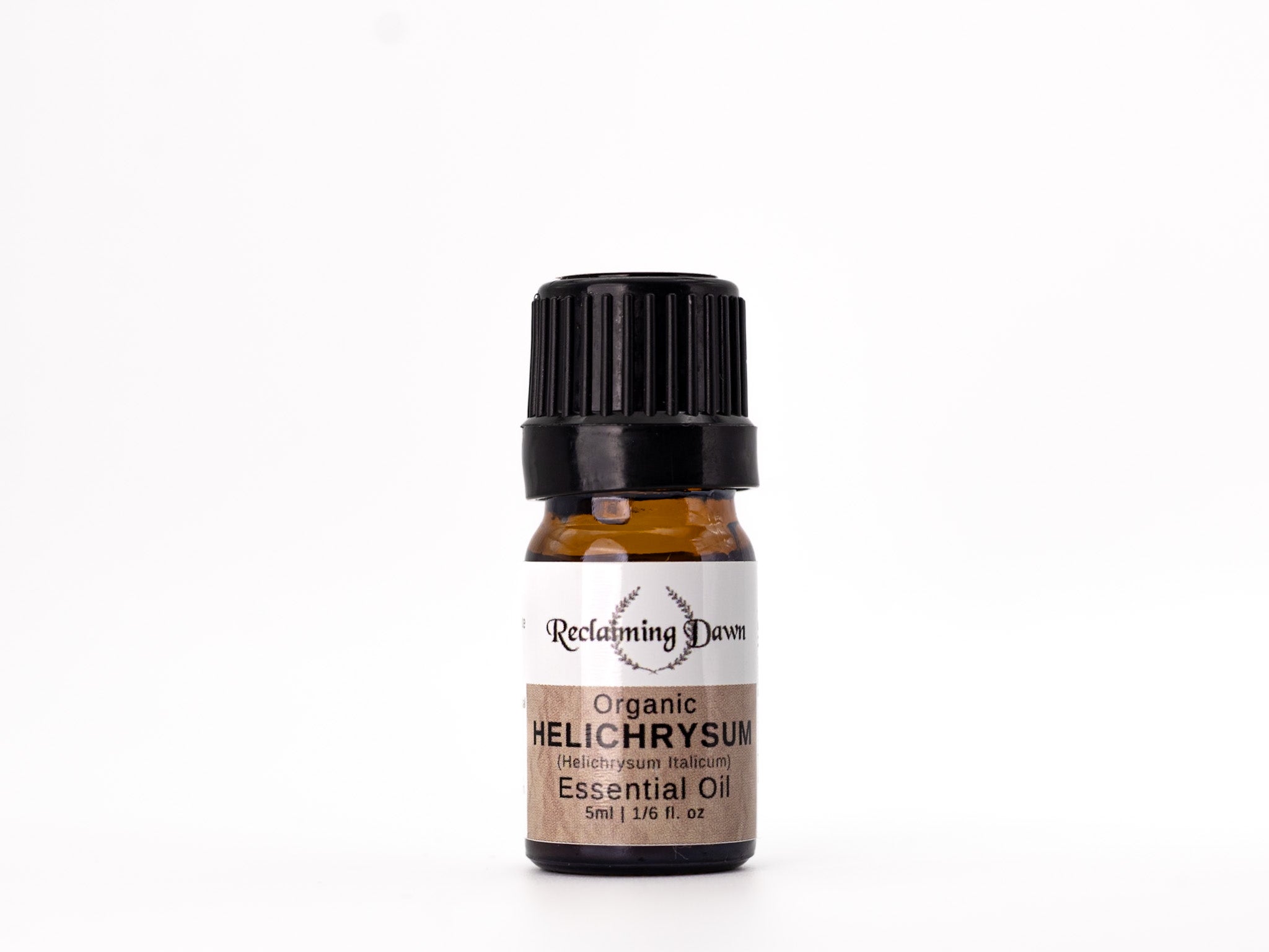 Bottle of Helichrysum essential oil with a white label on a white background