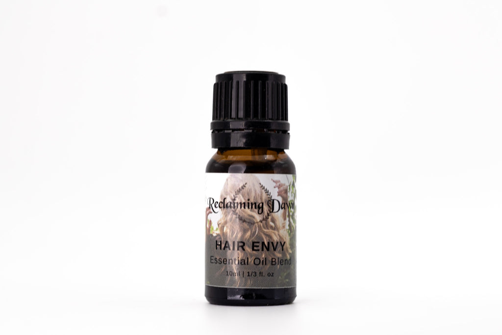 Bottle of 'Hair Envy' essential oil blend by Reclaiming Beauty on a white background