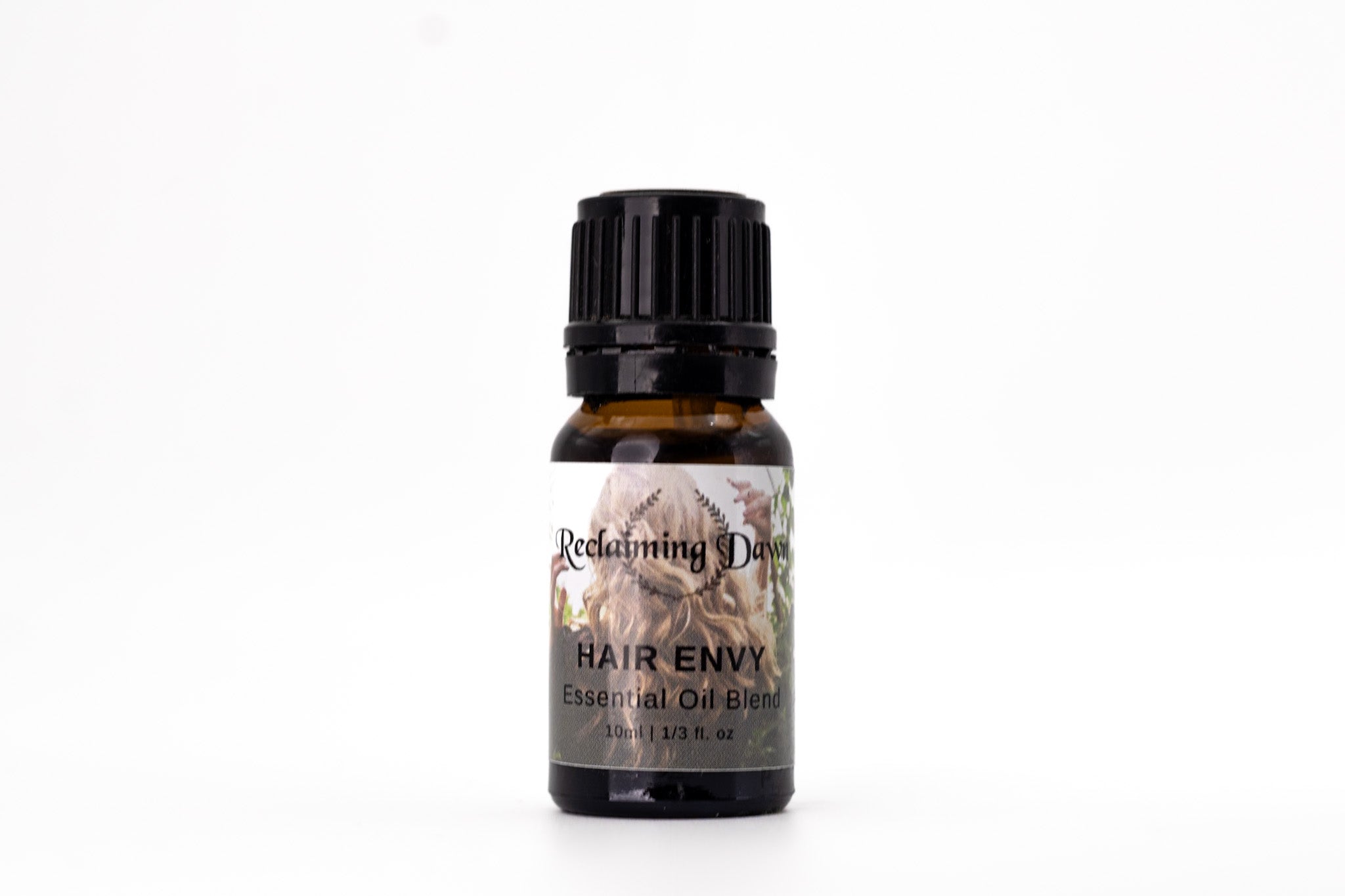 Bottle of 'Hair Envy' essential oil blend by Reclaiming Beauty on a white background