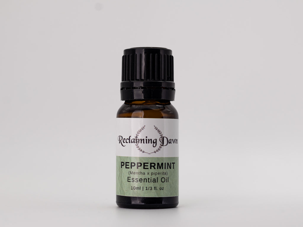 Bottle of peppermint essential oil with a label on a light gray background
