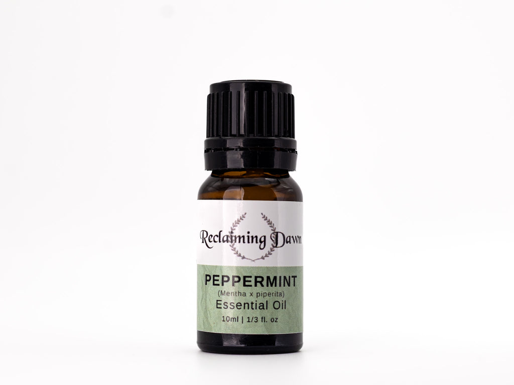 Bottle of peppermint essential oil with a label on a white background