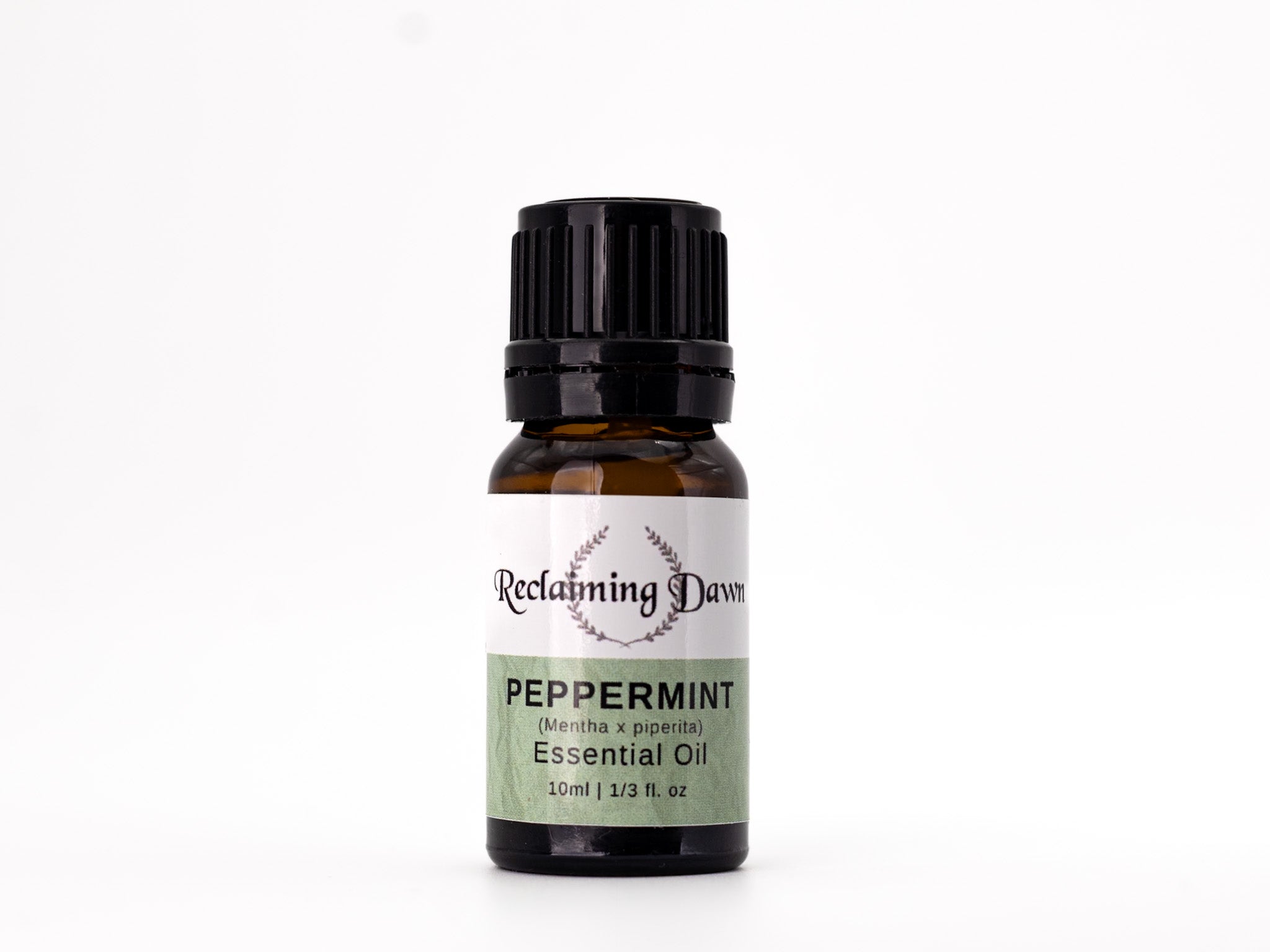 Bottle of peppermint essential oil with a label on a white background
