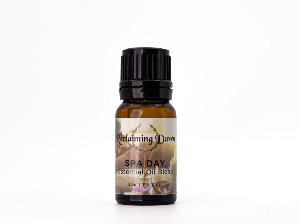 Essential oil blend bottle labeled 'Spa Day' by 'Reclaiming Dawn' on a white background