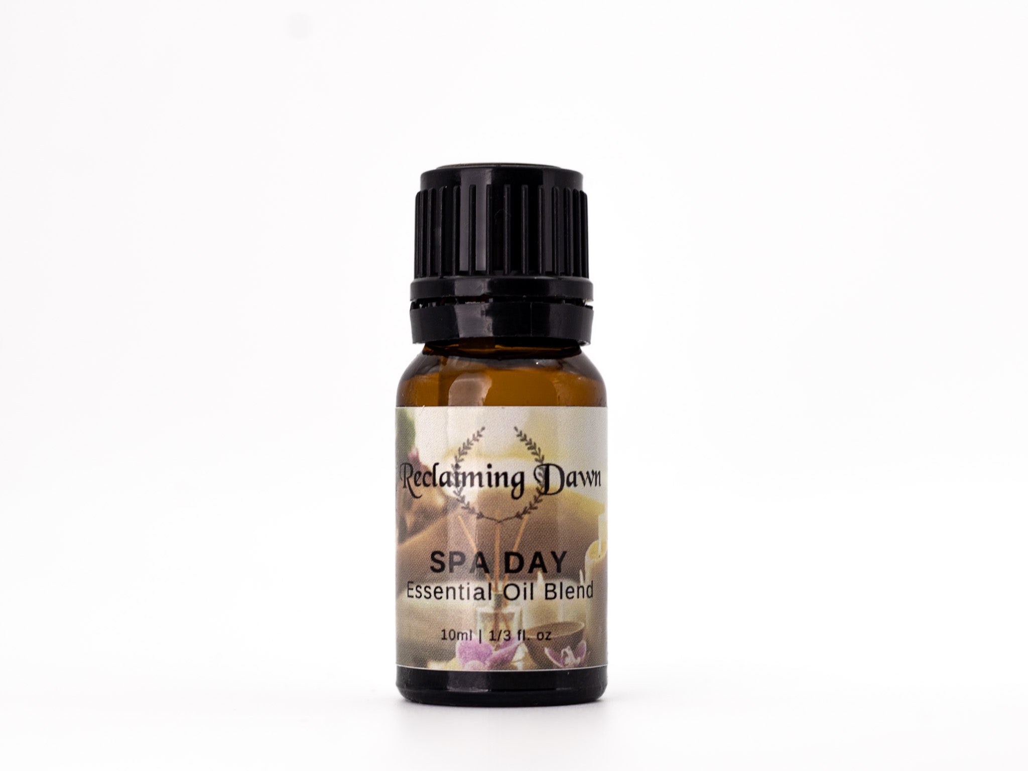 Essential oil blend bottle labeled 'Spa Day' by 'Reclaiming Dawn' on a white background