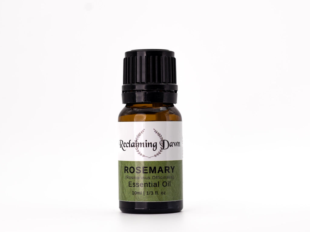 Rosemary essential oil bottle with 'Reclaiming Dawn' label on a white background