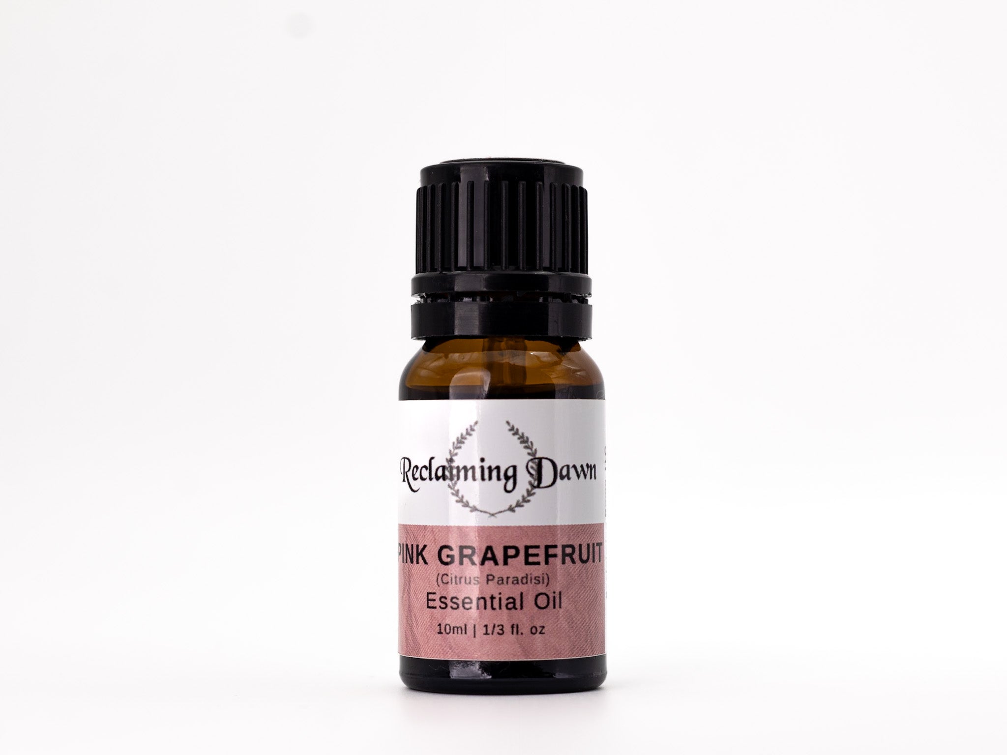 Bottle of Pink Grapefruit essential oil with a black cap on a white background