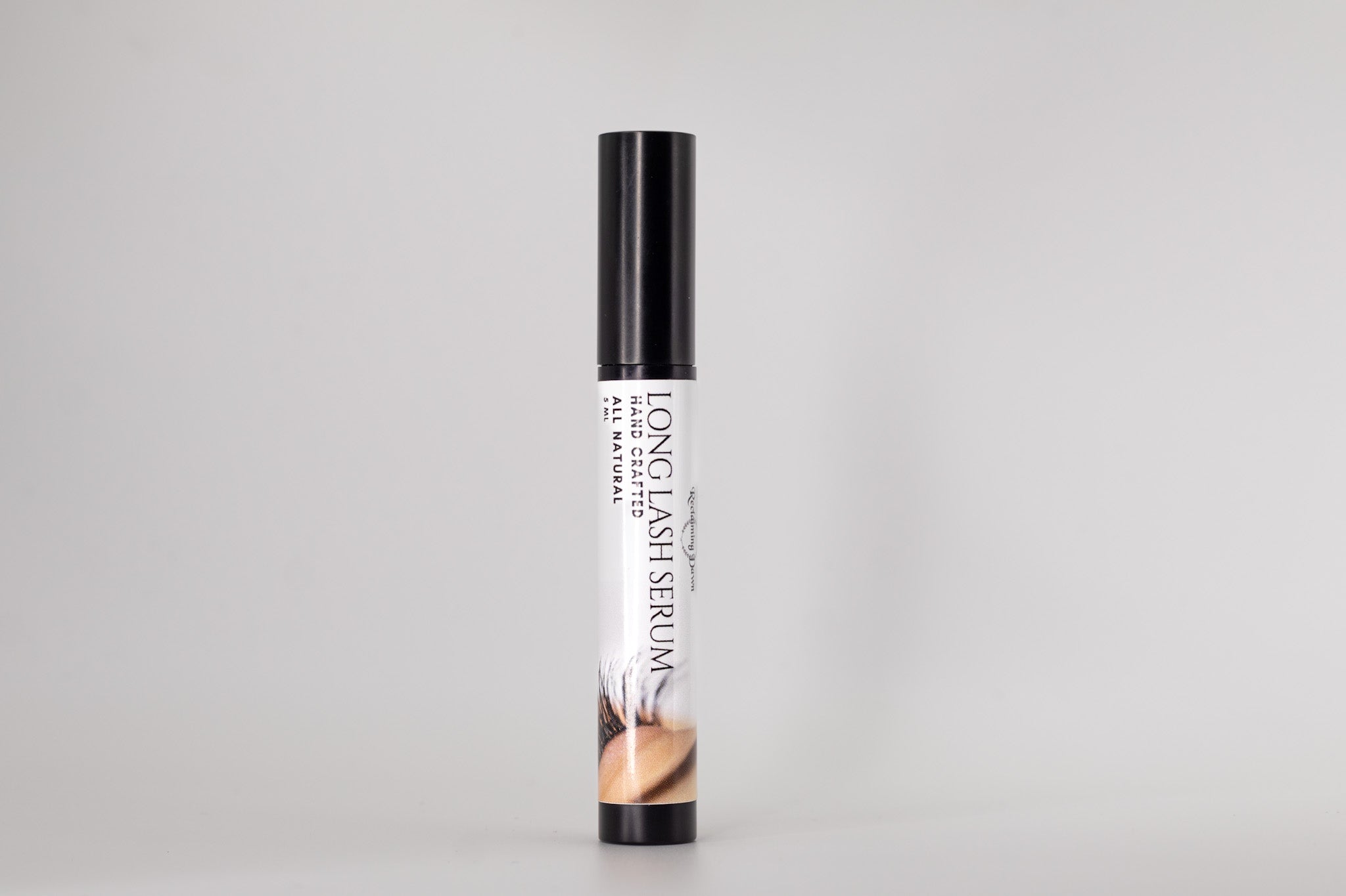Long Lash Serum bottle on a light gray background