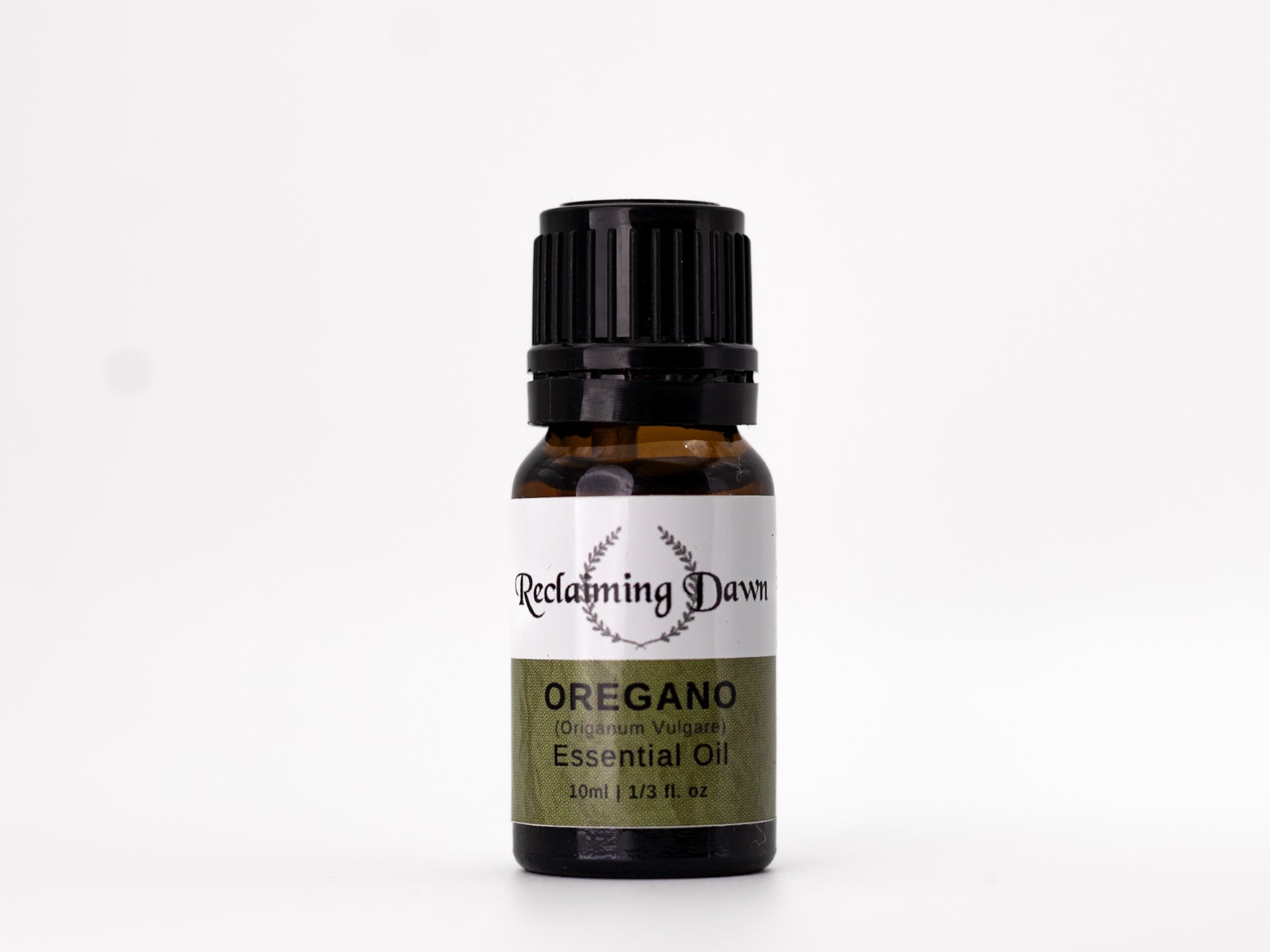 Bottle of Oregano essential oil with 'Reclaiming Dawn' label on a white background
